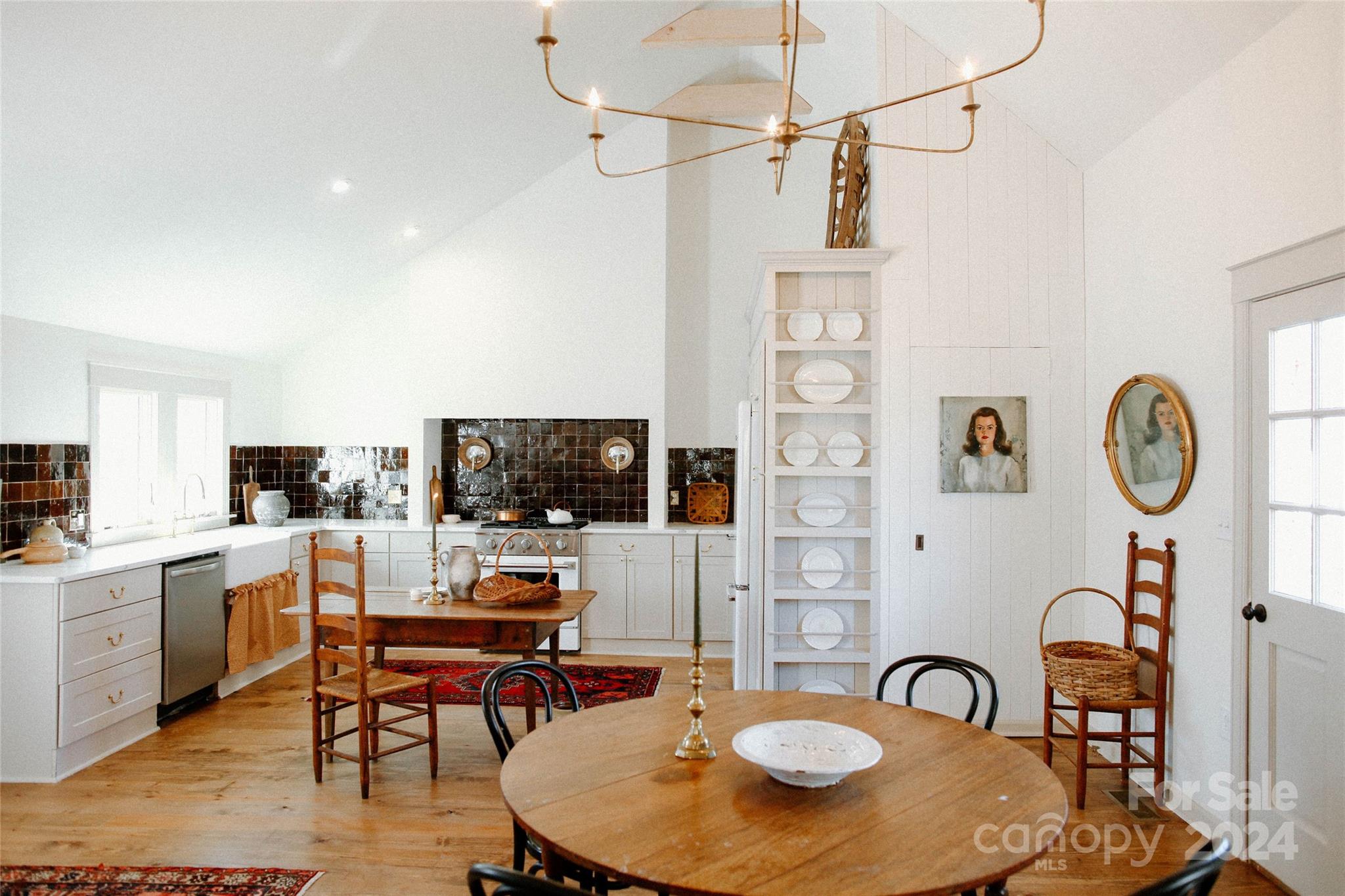 a living room with furniture a flat screen tv and kitchen view