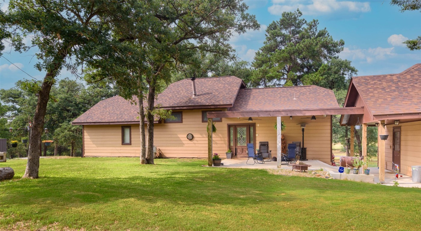 a front view of a house with a garden and tree