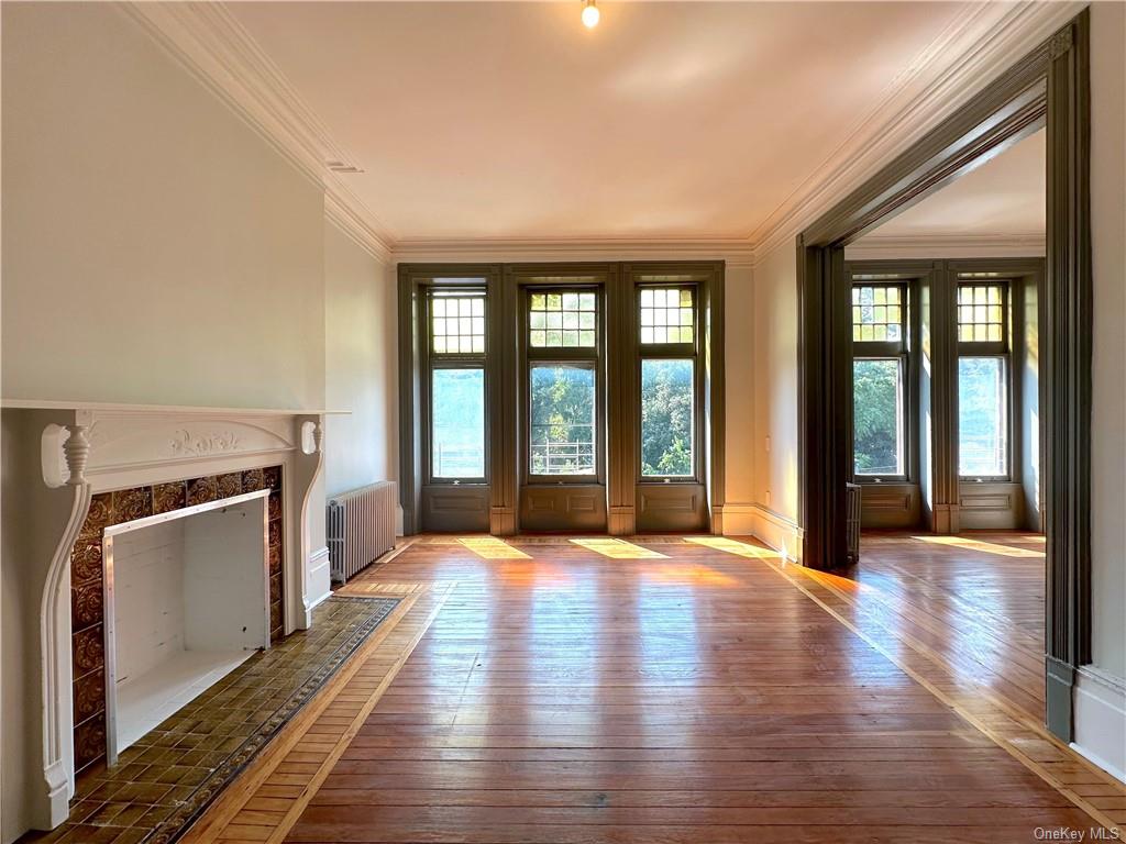 a view of an empty room with glass door and a window