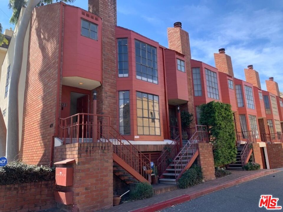 a front view of a building with garden