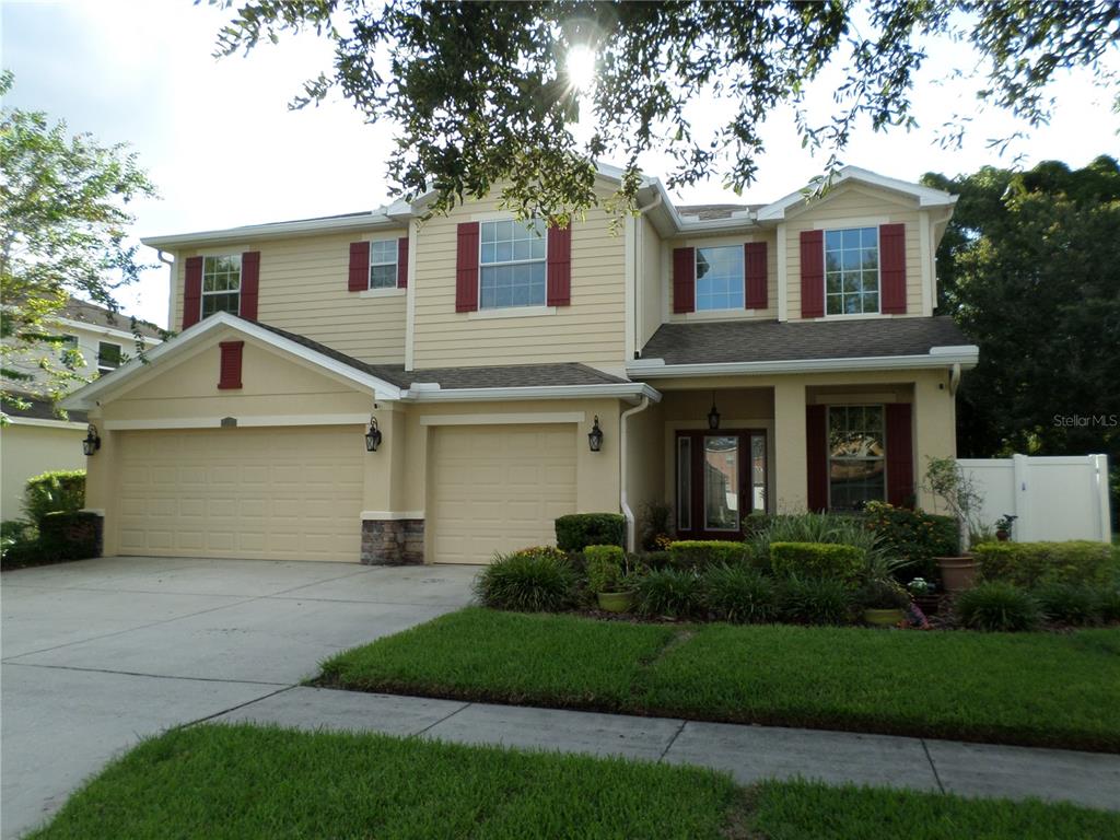 a front view of a house with a garden and plants