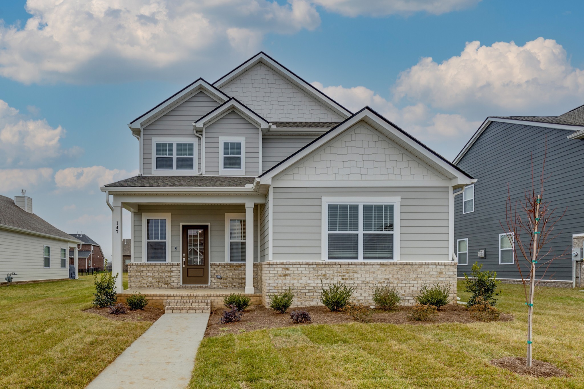 a front view of a house with a yard