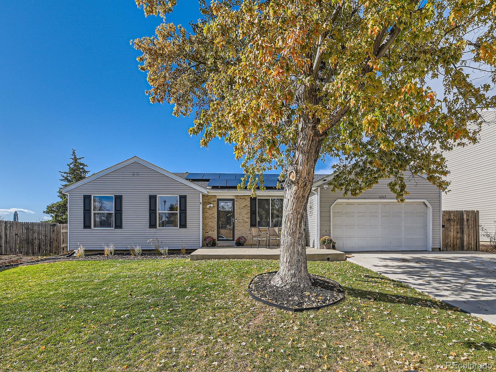 a front view of house with yard and trees