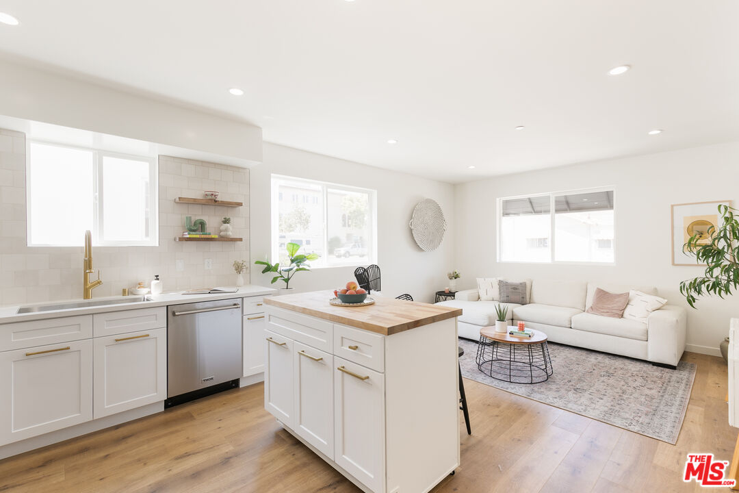 a view of a kitchen counter space with wooden floor and a window