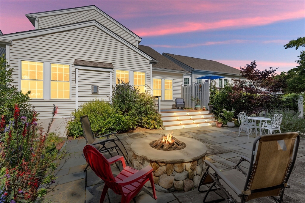 a view of a house with backyard and sitting area