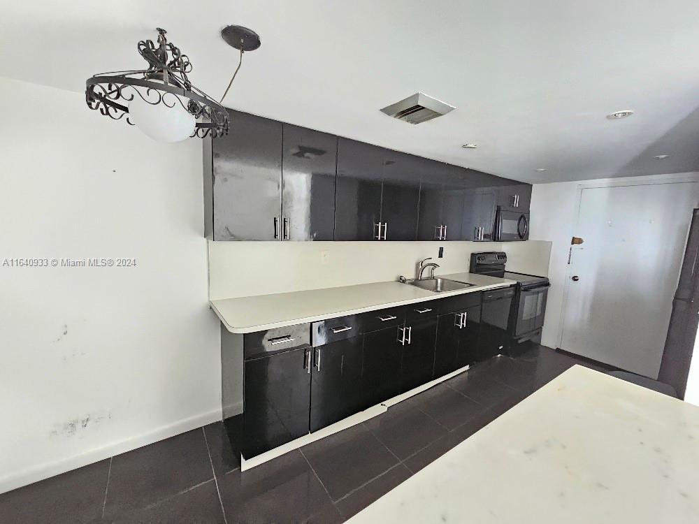 a kitchen with a sink and cabinets