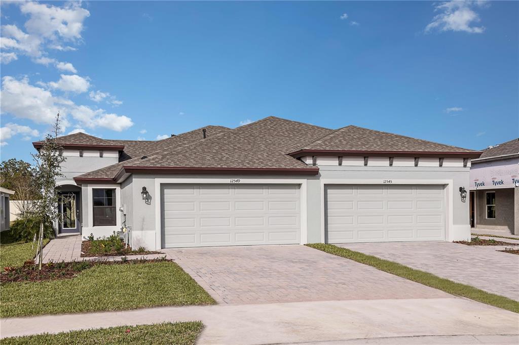 a front view of a house with a garden and yard