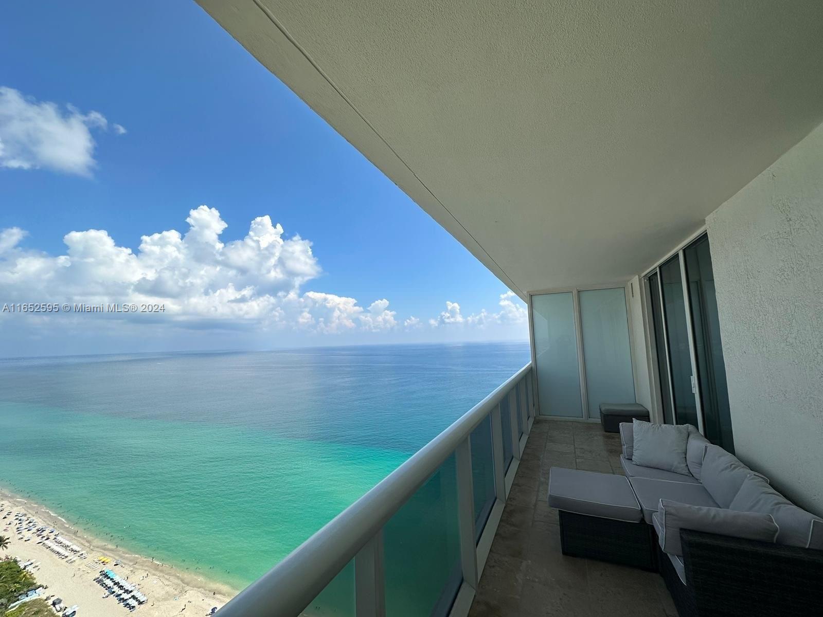 a view of a balcony with furniture