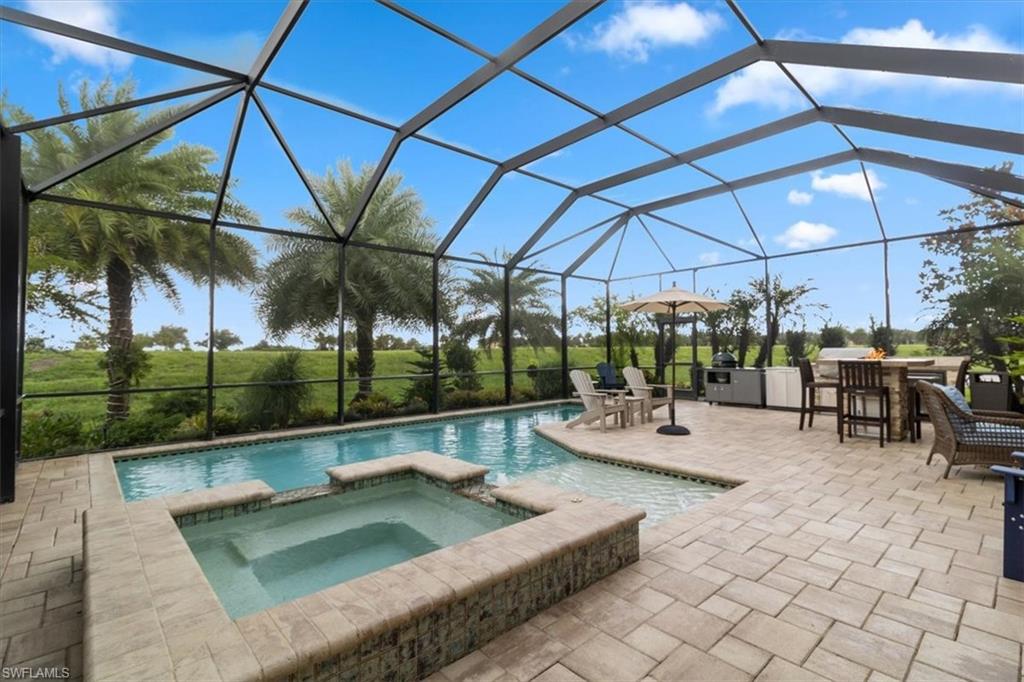 a view of a patio with a table and chairs under an umbrella