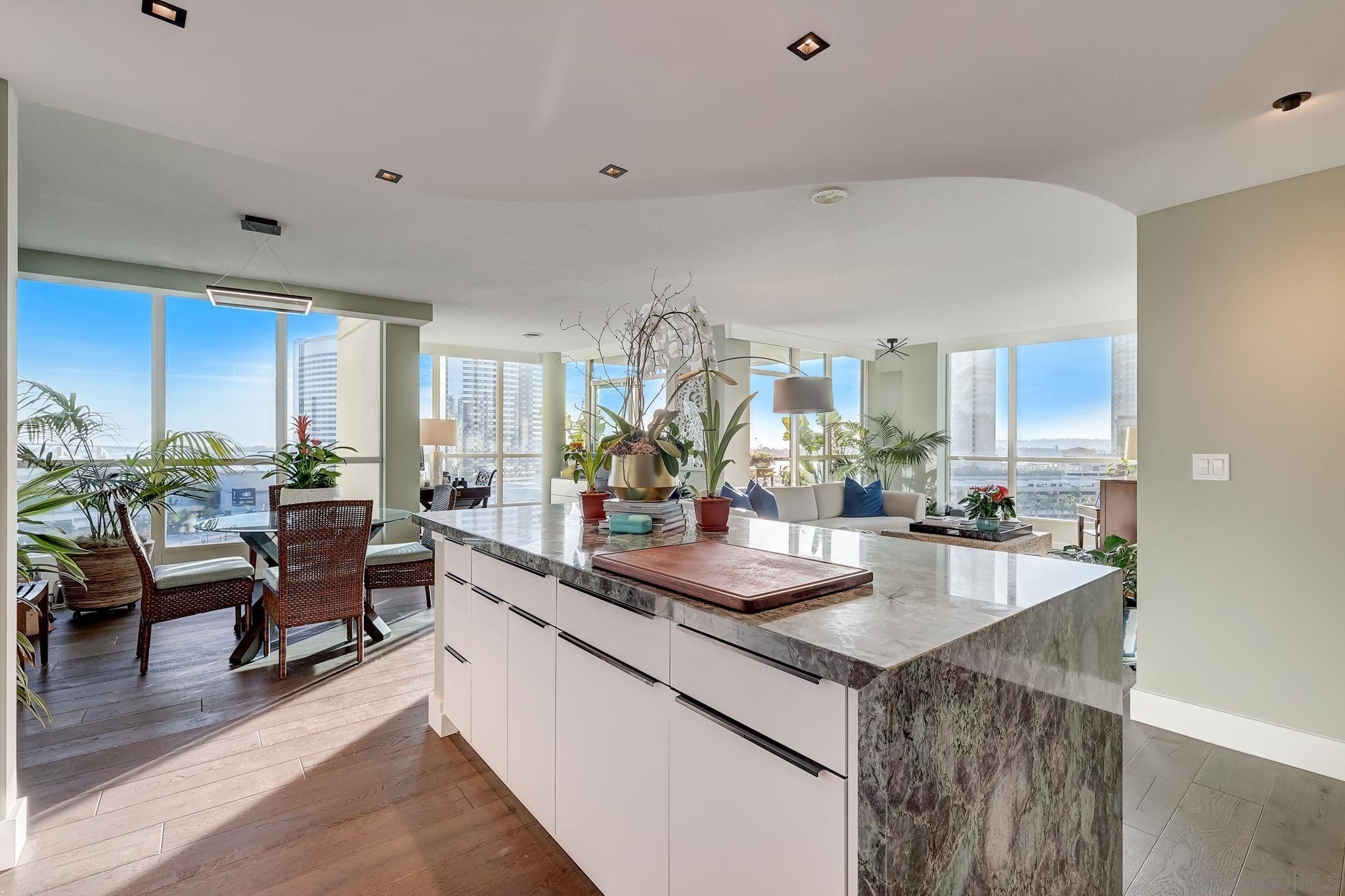 a kitchen with sink and living room view