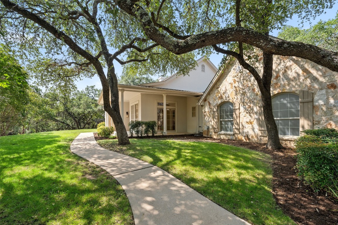 a view of a house with backyard porch and sitting area