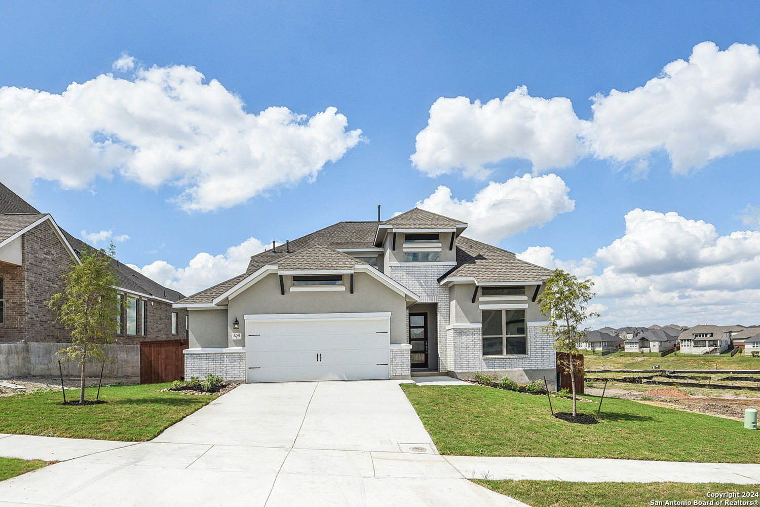 a front view of a house with garden