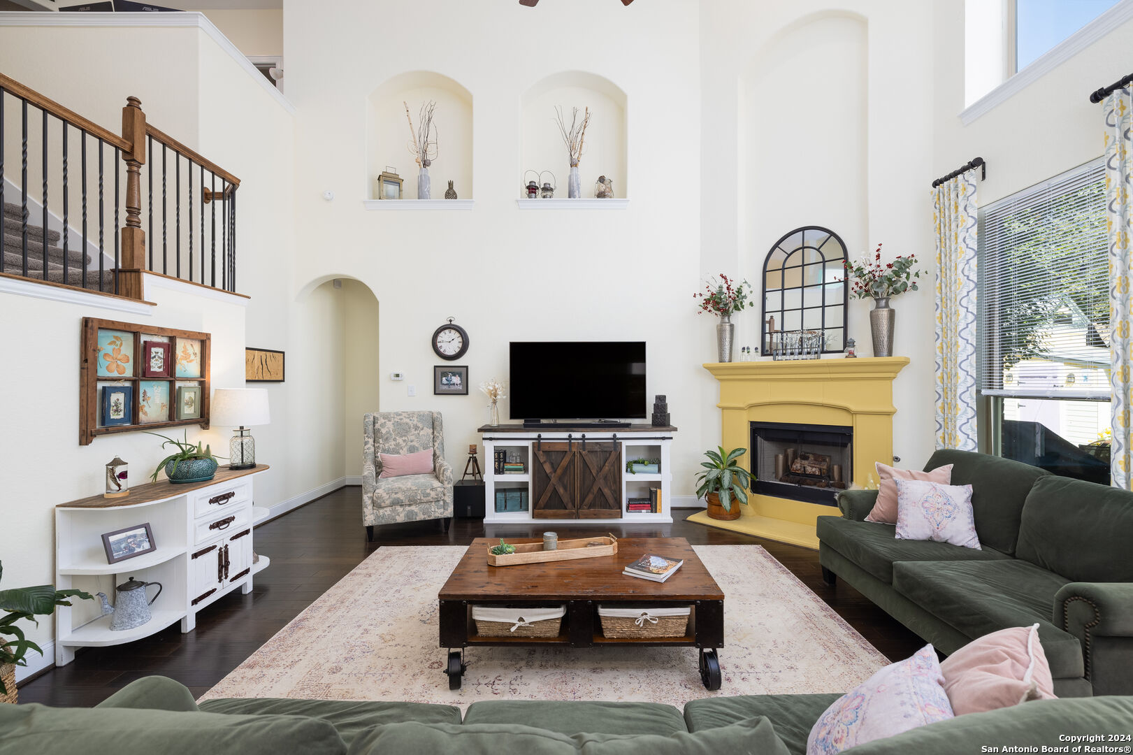 a living room with furniture and a fireplace