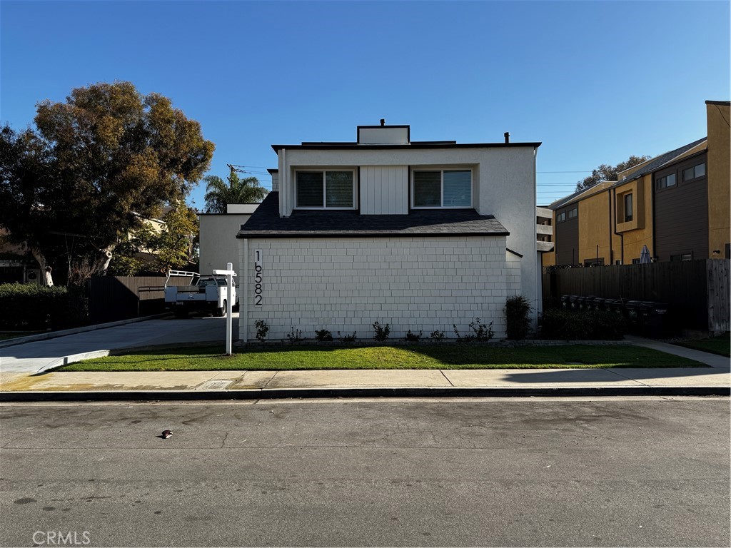 a view of house with outdoor space and parking