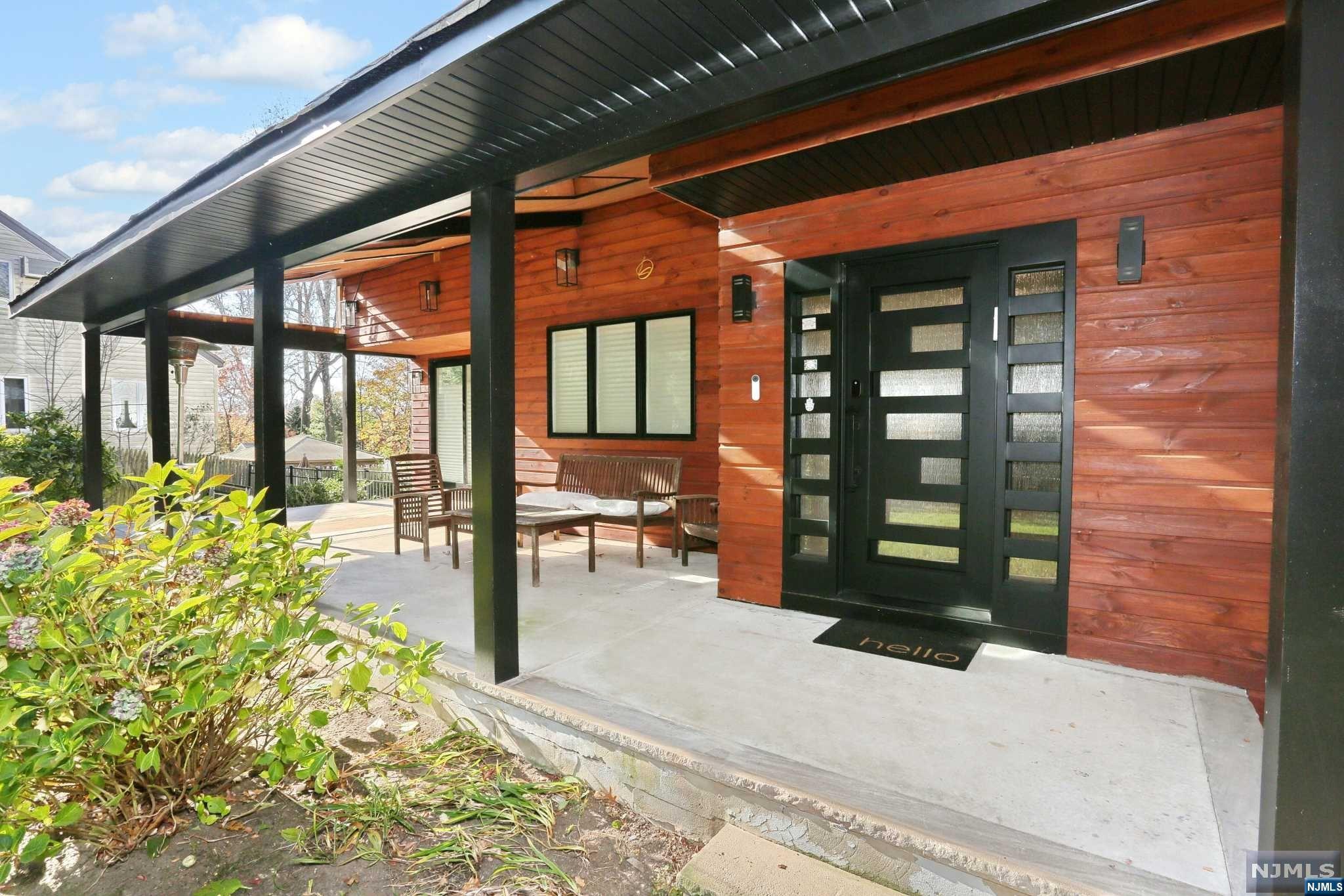 a view of a porch with chairs and backyard