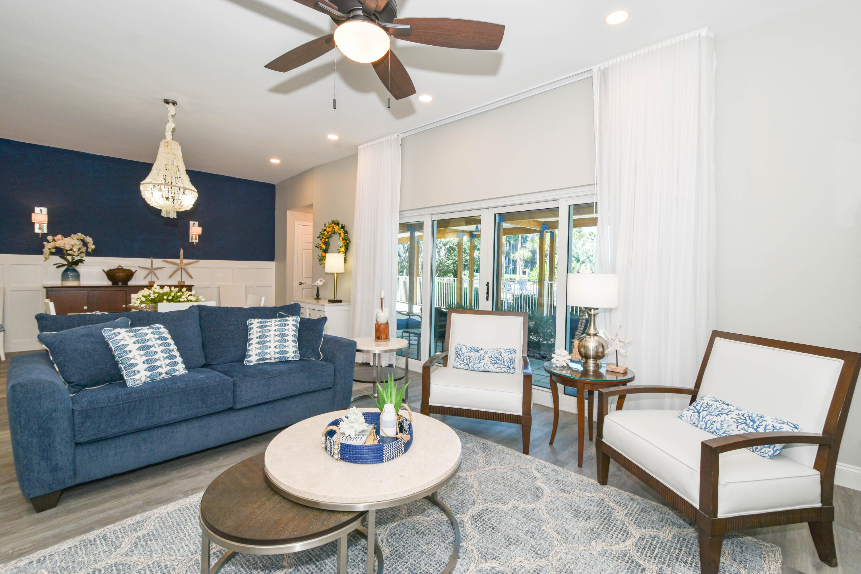 a living room with furniture and a dining table with kitchen view