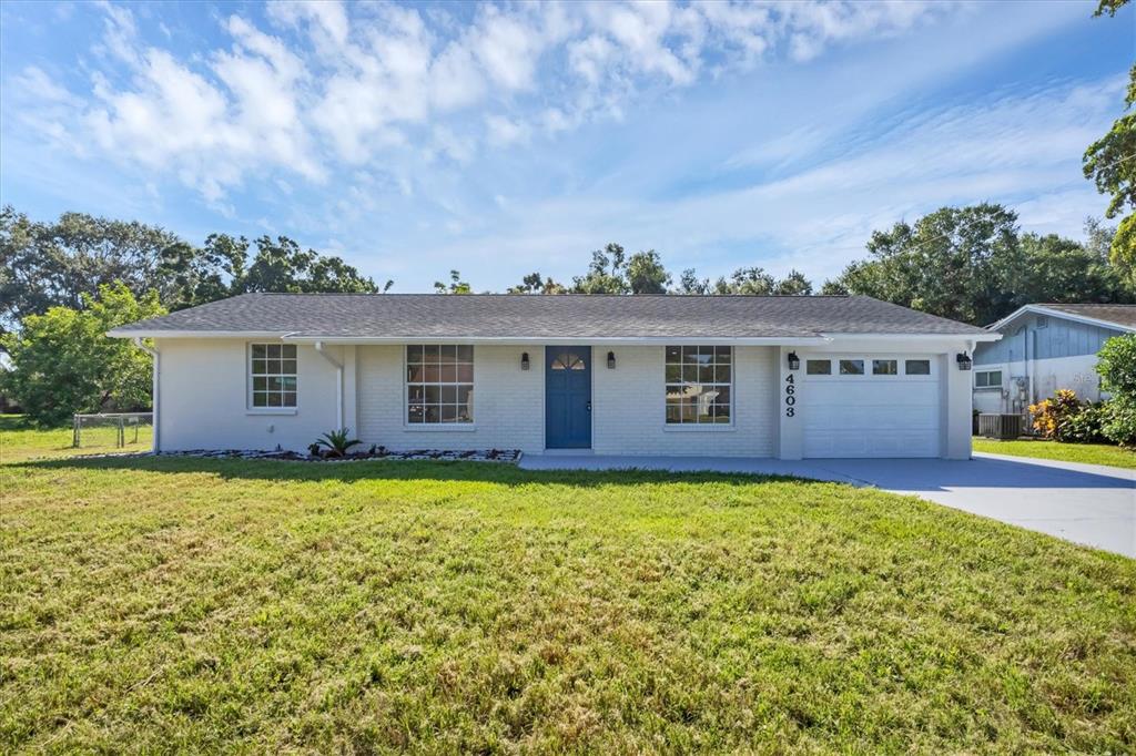 front view of a house with yard next to a yard