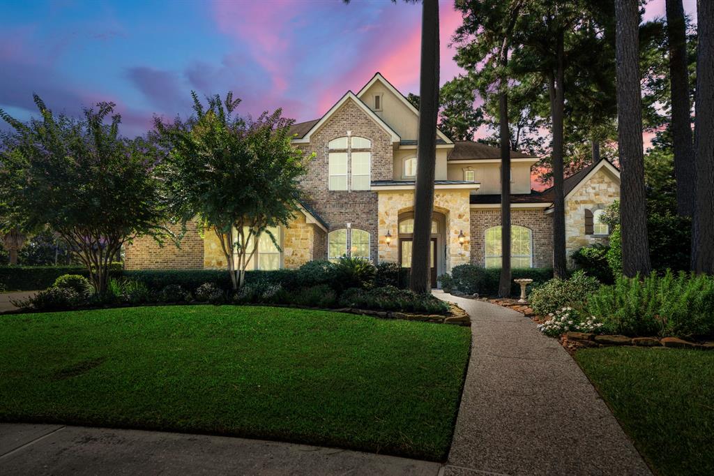 a front view of a house with a garden and yard