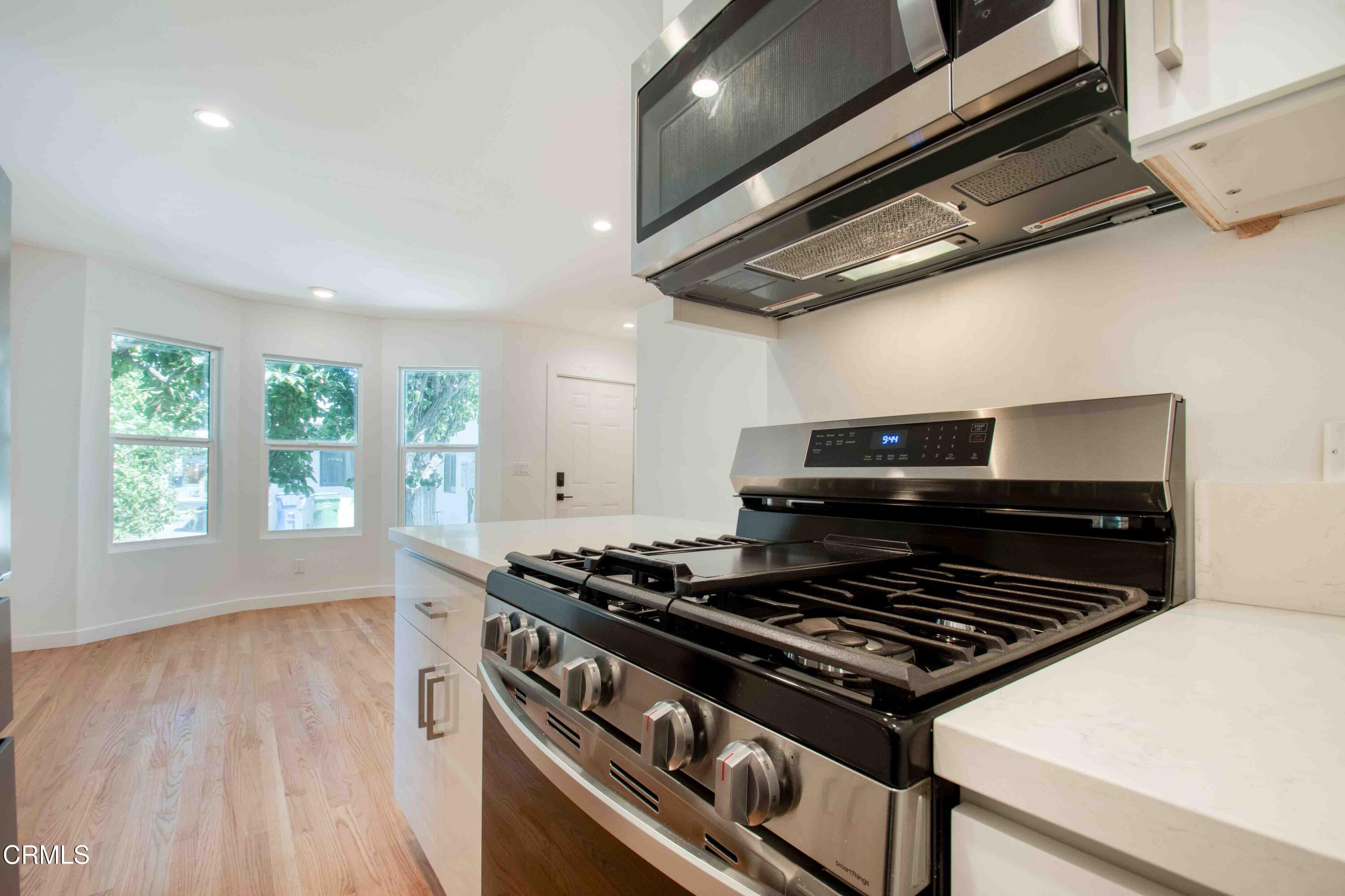 a stove top oven sitting inside of a kitchen