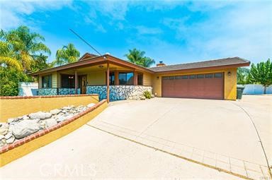 a view of house with yard outdoor seating and entertaining space