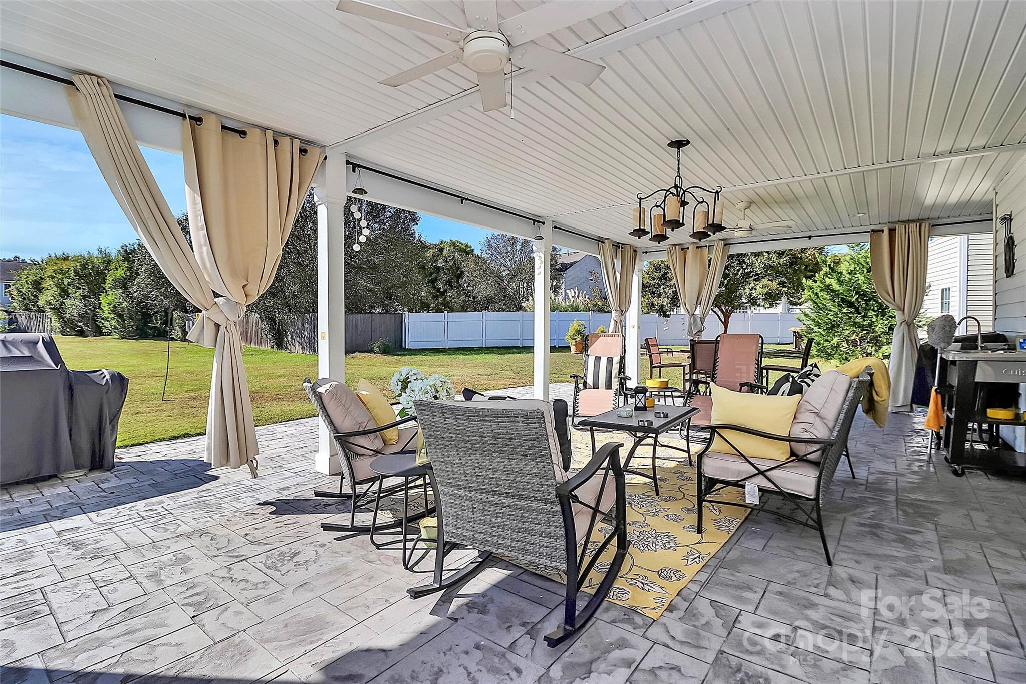 a view of a patio with dining table and chairs