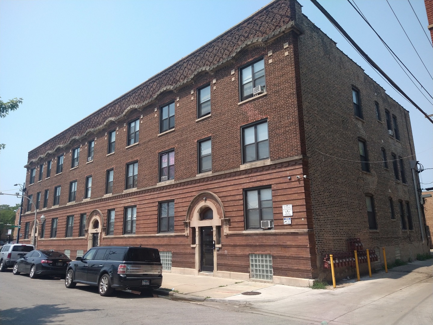 a front view of a building with parking space