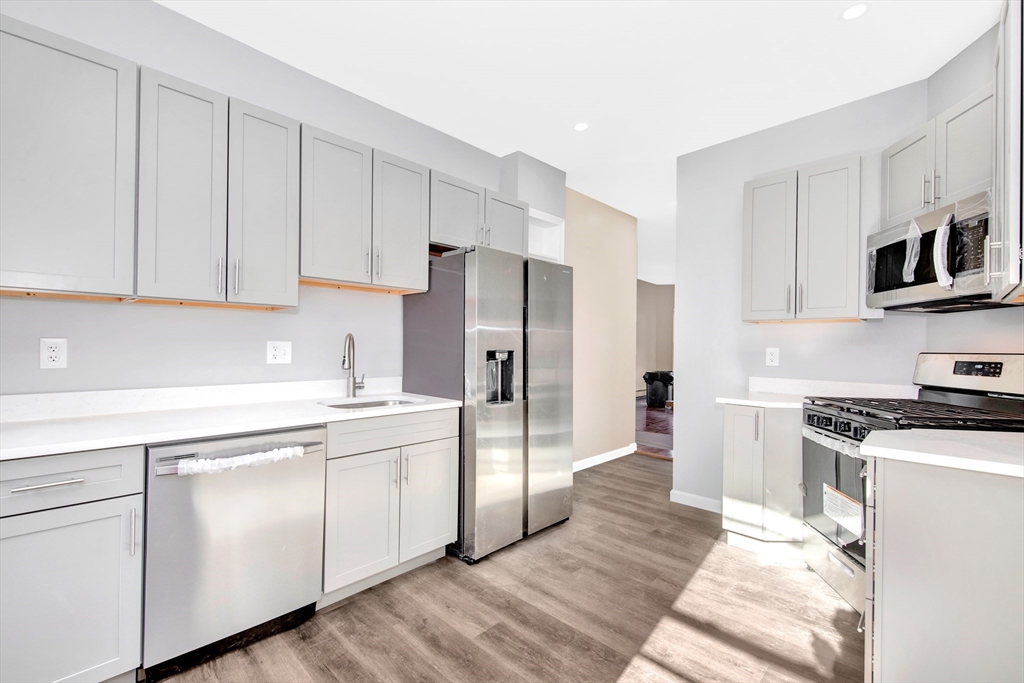 a kitchen with cabinets and stainless steel appliances