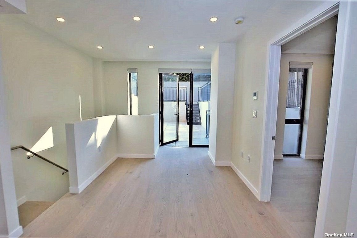 a view of an empty room with closet and a window