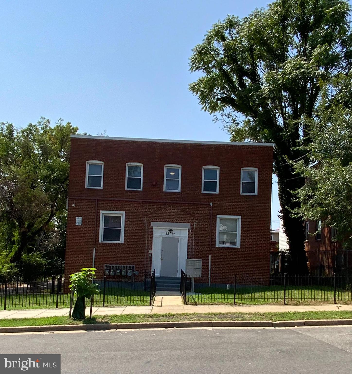 a brick building with a tree in front of it