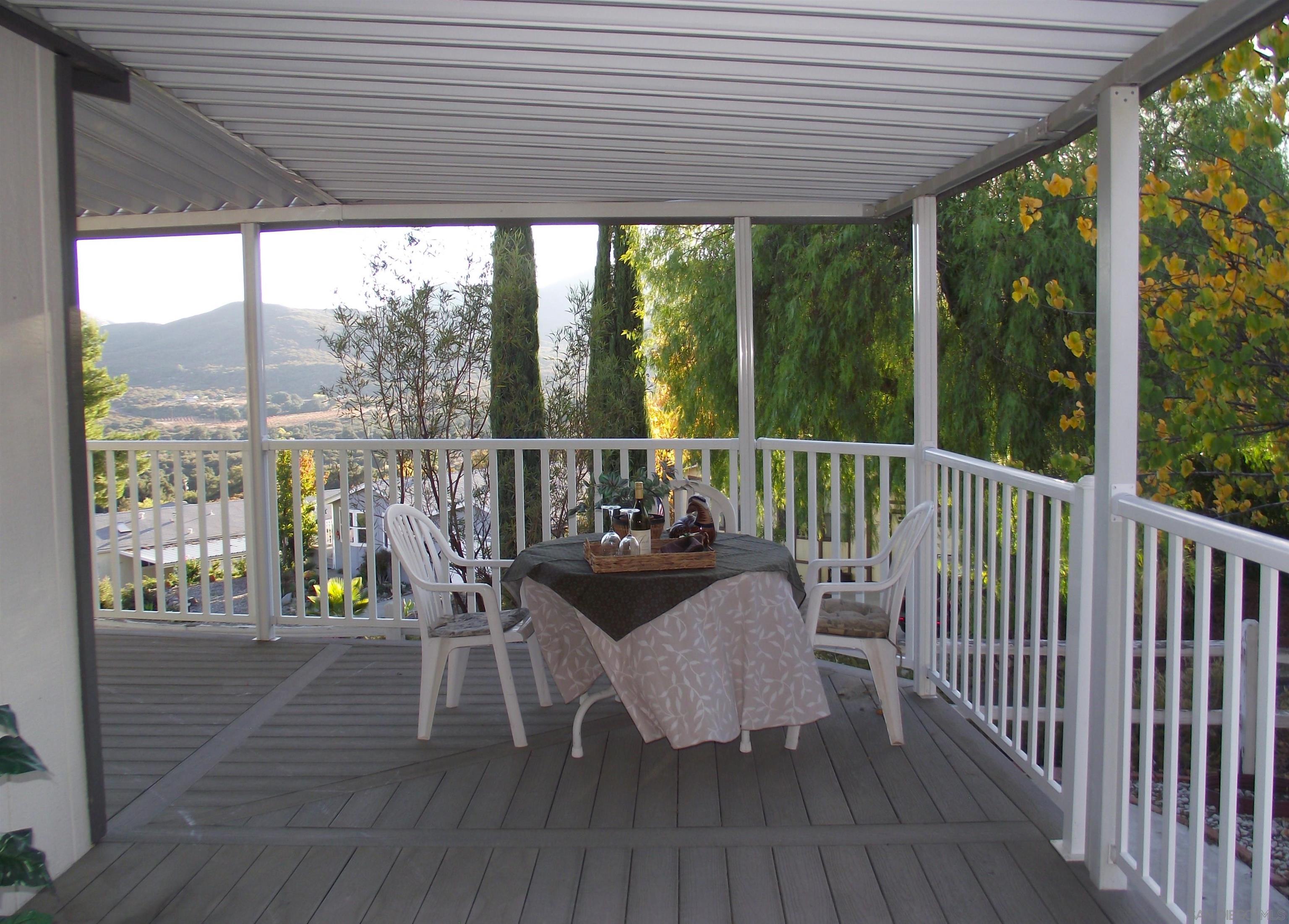 a view of a balcony with furniture and wooden floor