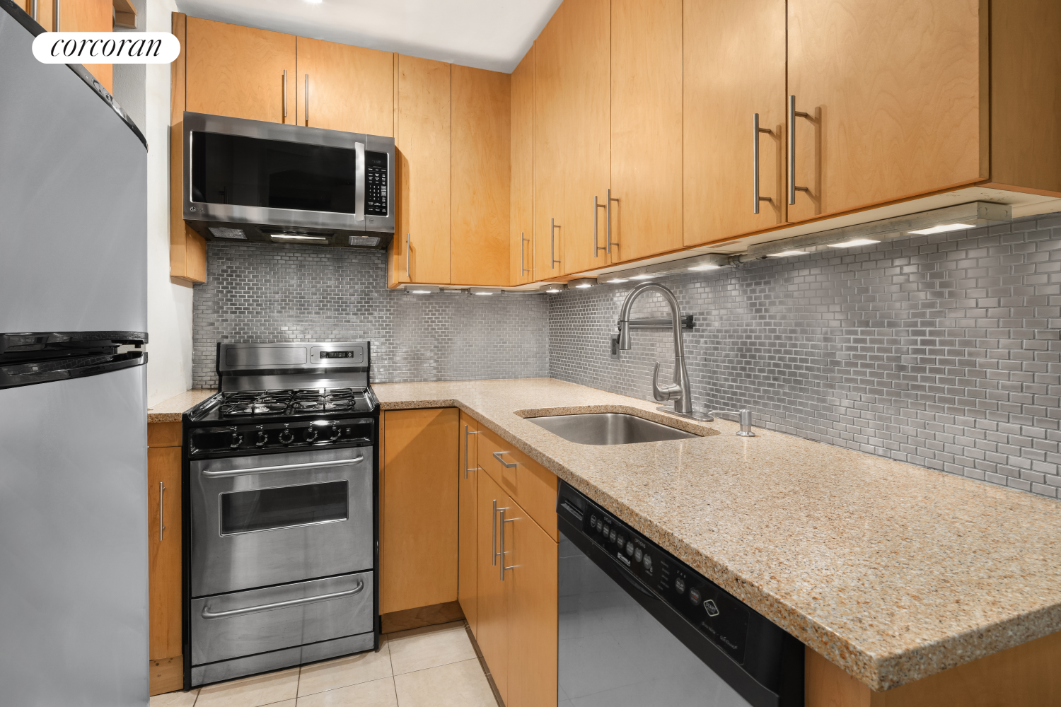 a kitchen with granite countertop a sink a stove and microwave