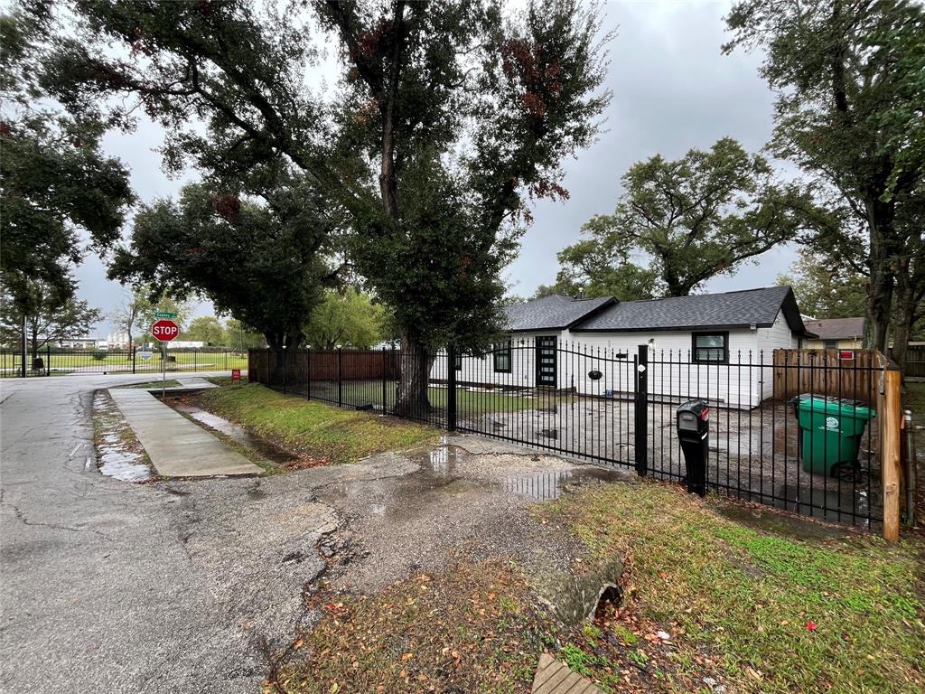 a view of a yard with wooden fence