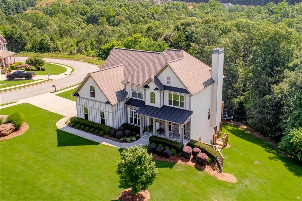 a aerial view of a house with swimming pool and big yard