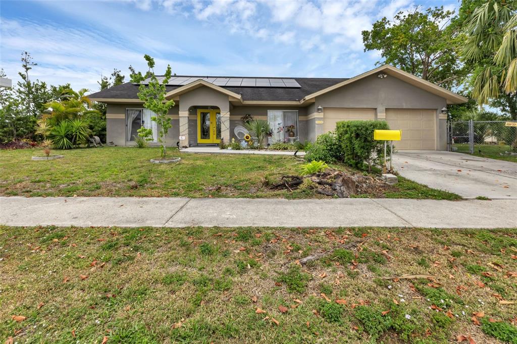 a front view of a house with a yard and a garage