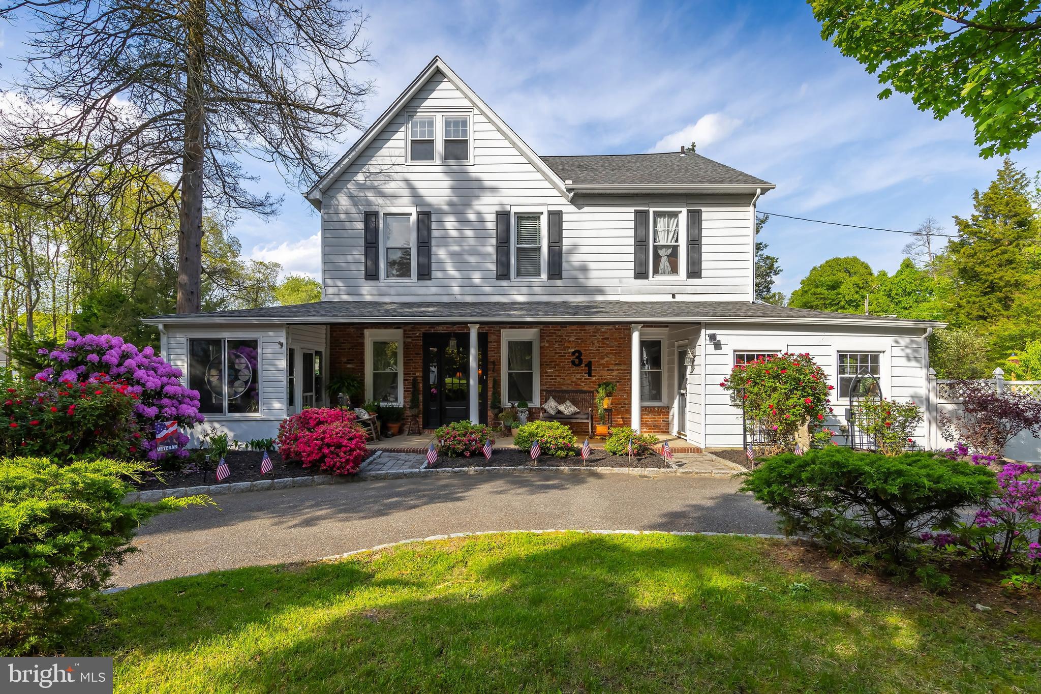 a front view of a house with a garden and plants