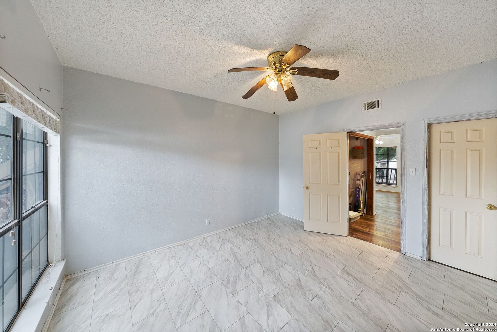 wooden floor in an empty room with a window