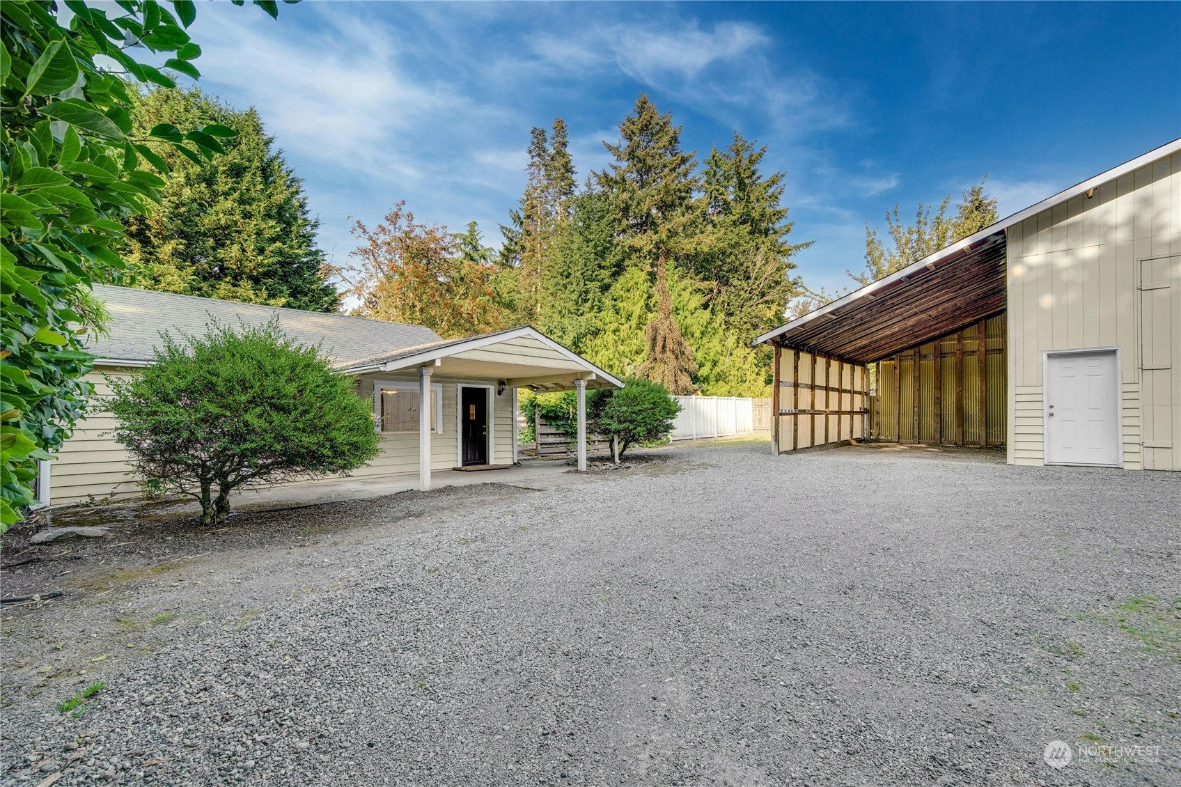 a view of a house with a yard and tree