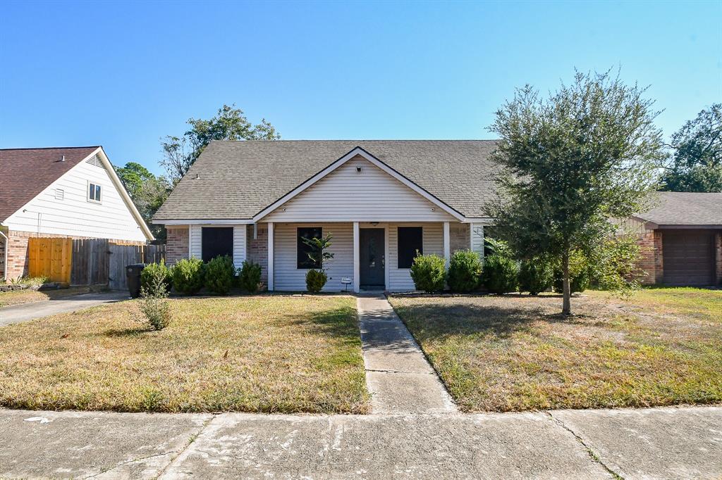 a front view of houses with yard