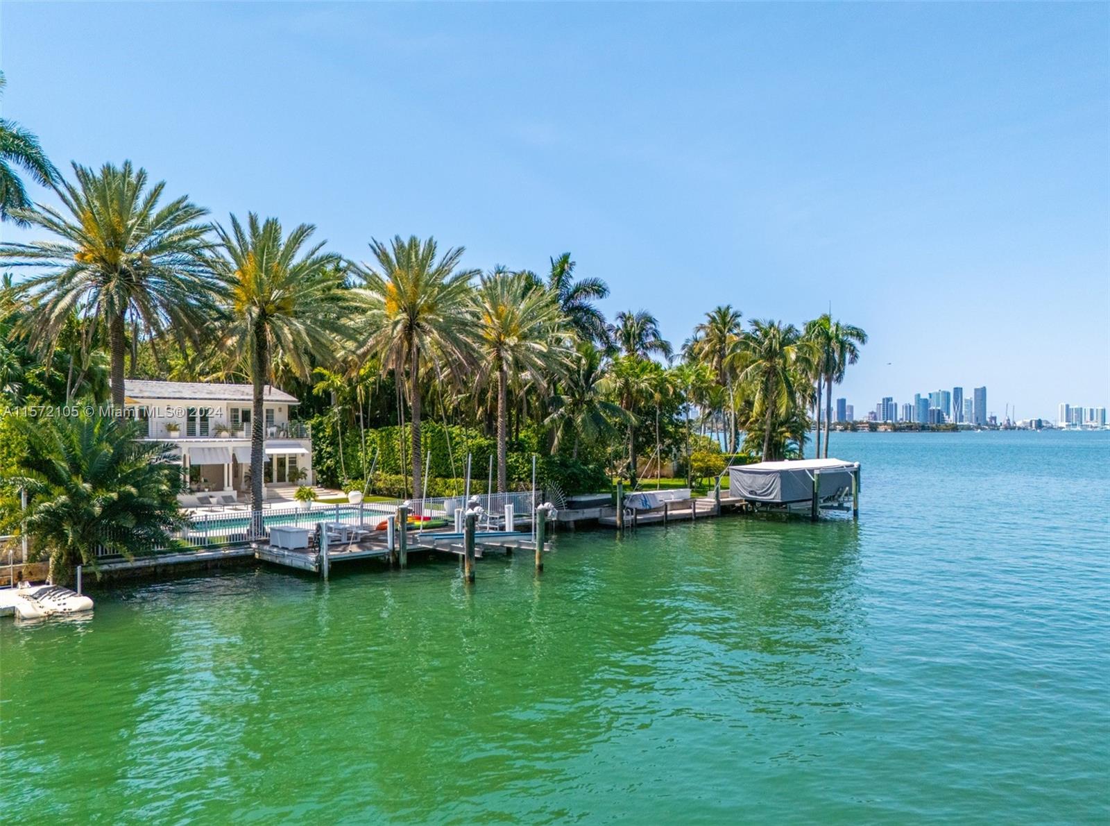 a view of a ocean with boats and palm trees