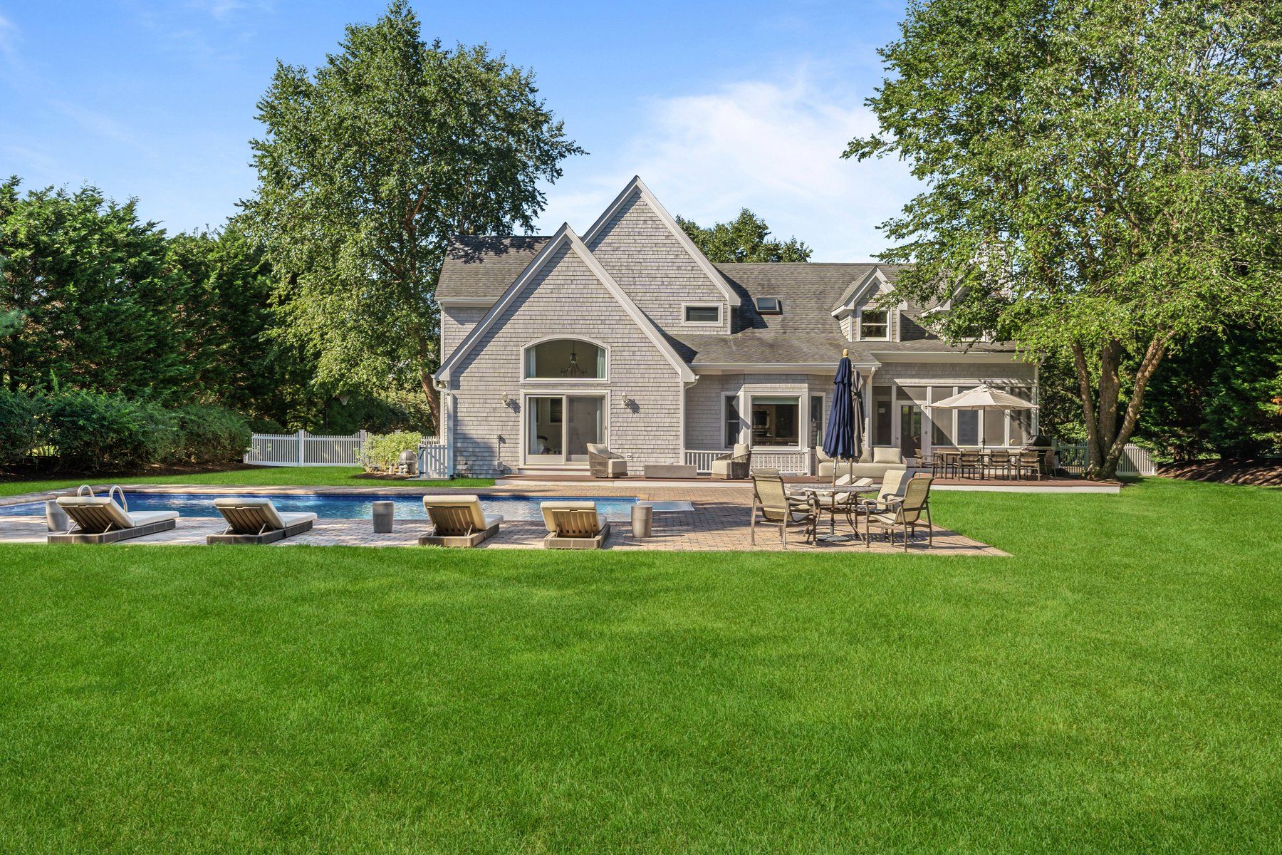 a view of a house with a yard and sitting area