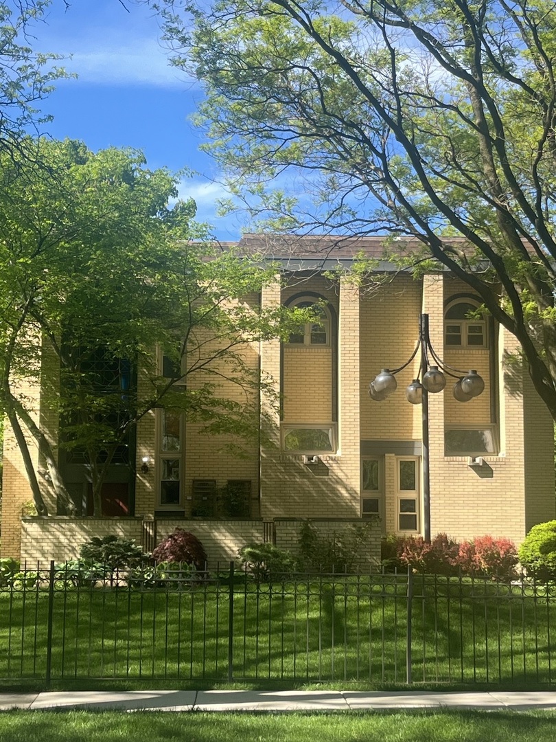 a view of a brick building next to a yard