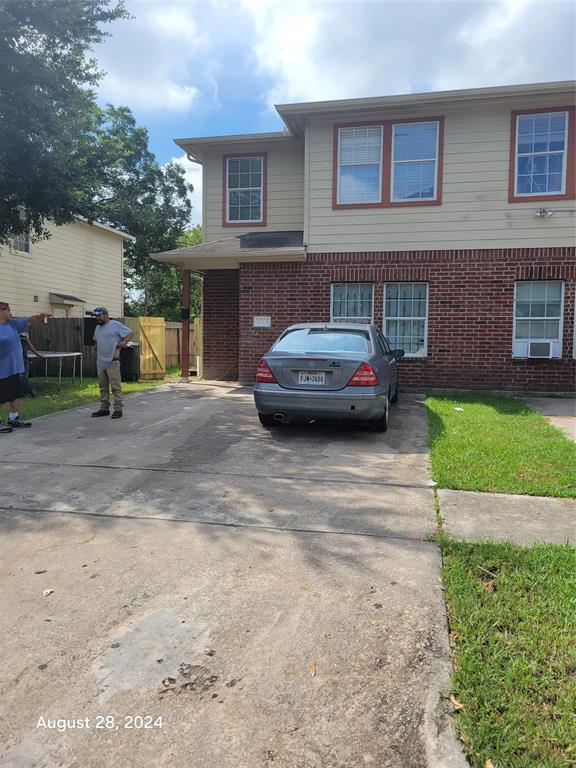 a view of a car parked in front of a brick house