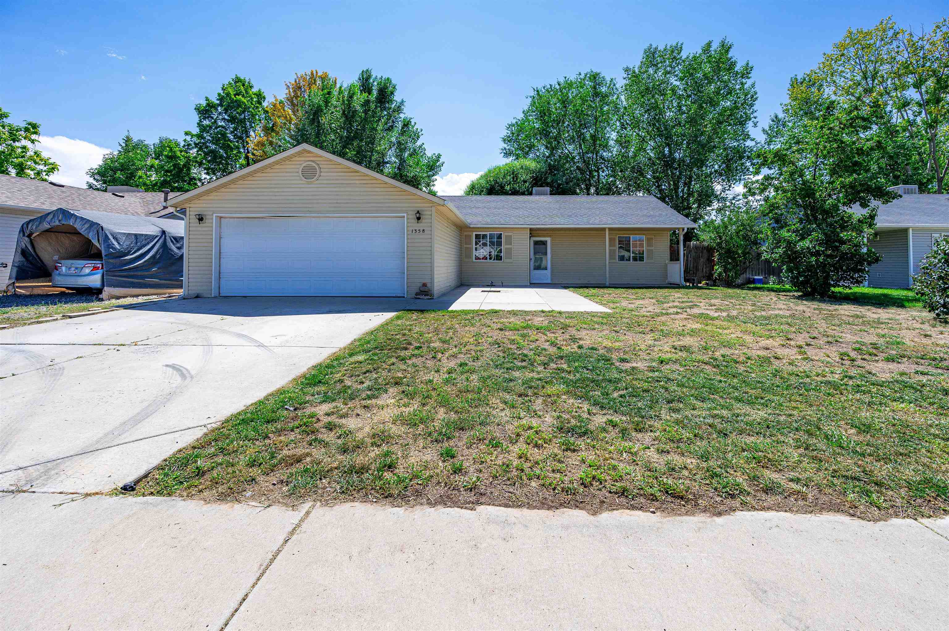 a front view of house with yard and trees