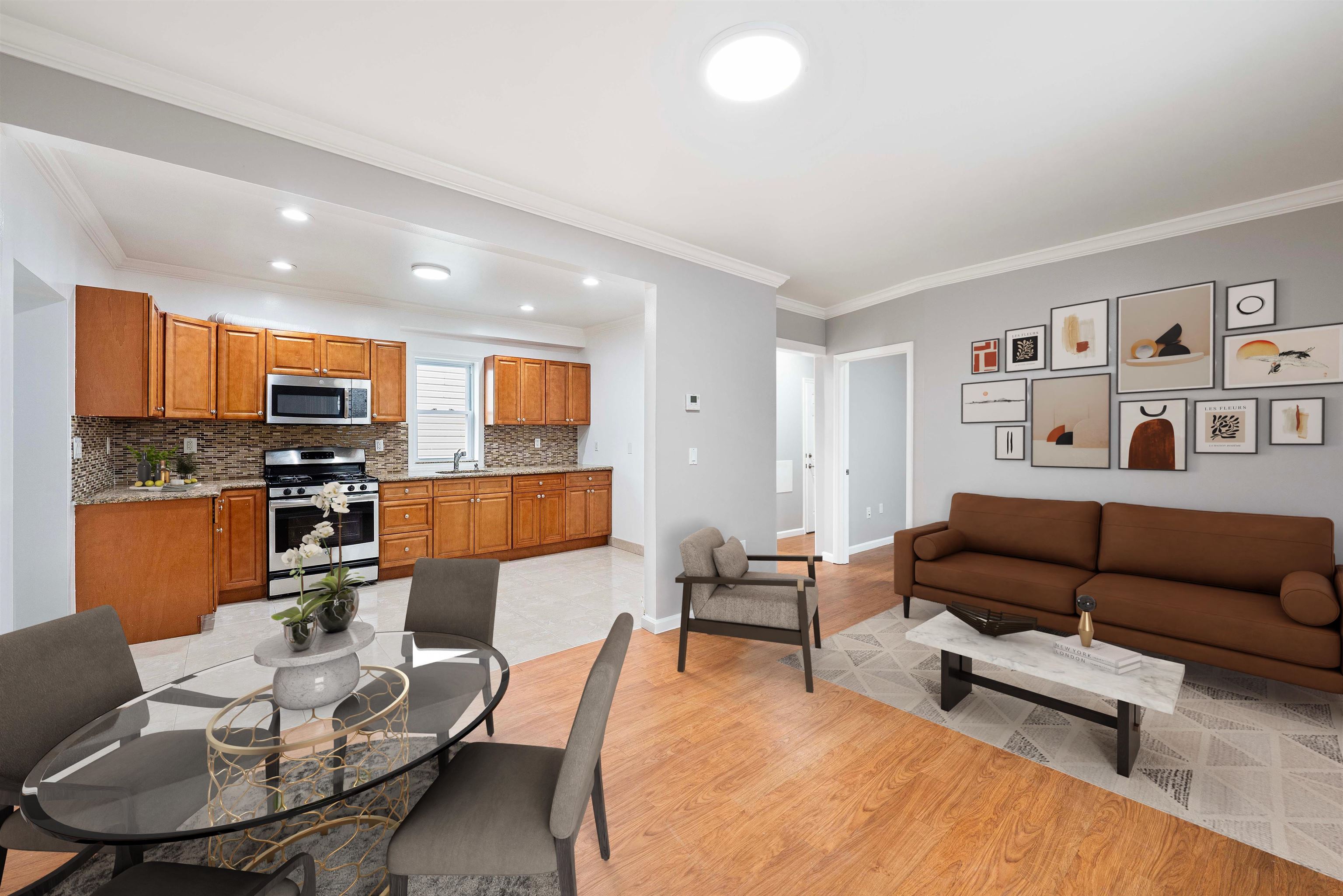 a living room with furniture kitchen and a wooden floor