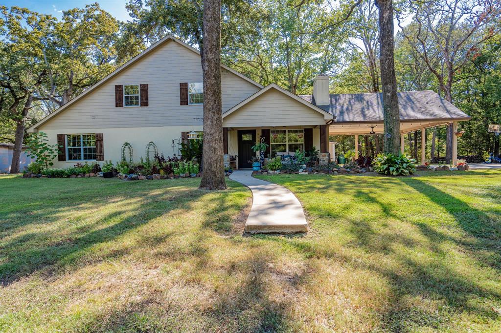 a front view of a house with a yard table and chairs