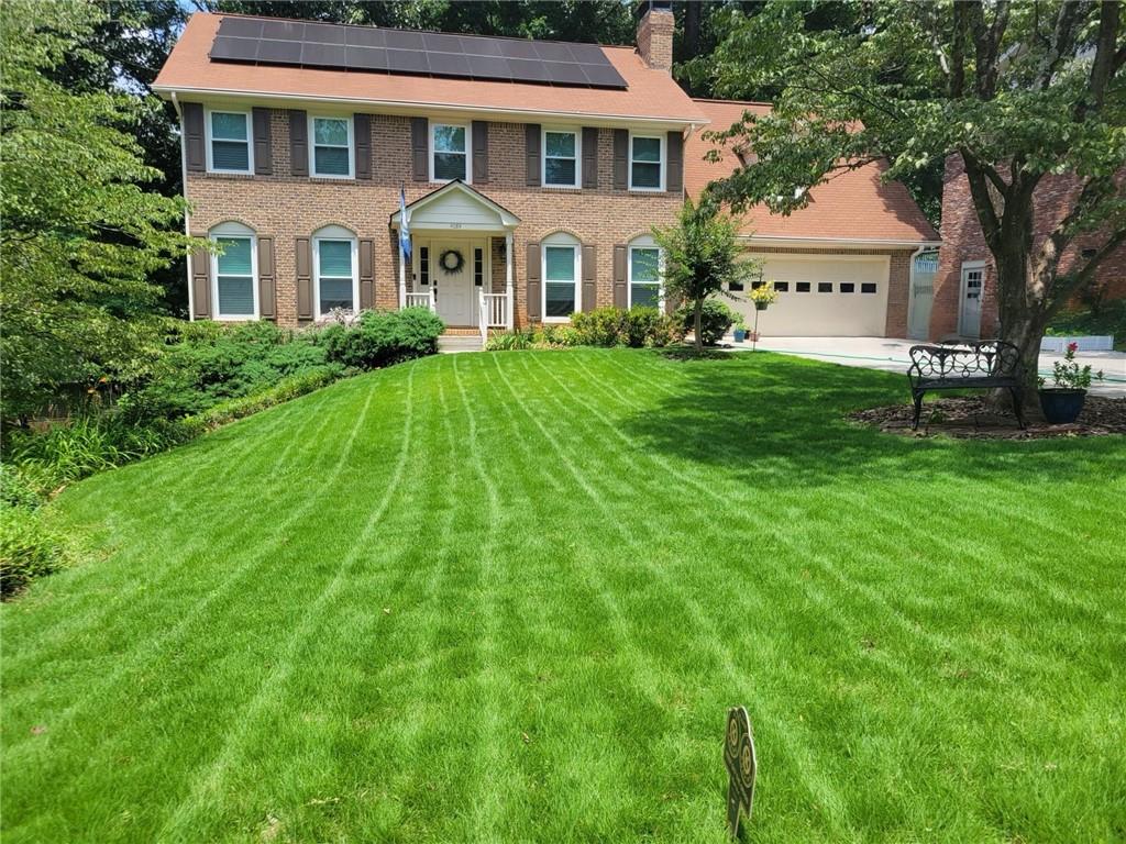 a front view of a house with a yard