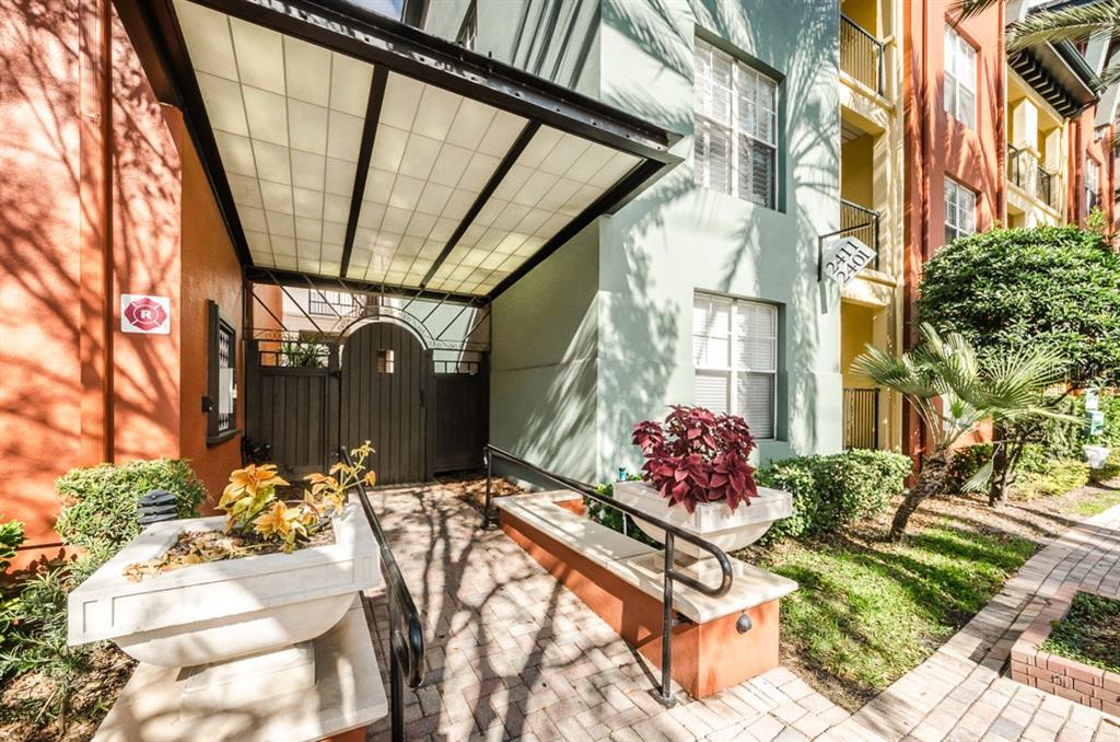 a view of backyard with a table and chairs and potted plants