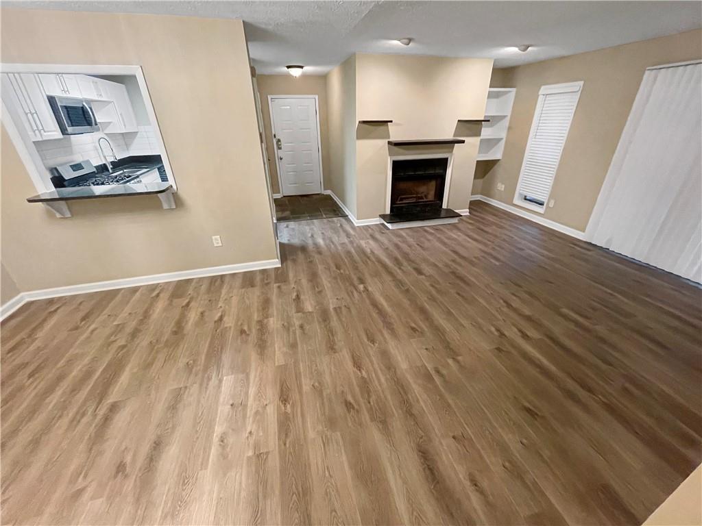 a view of a kitchen with a sink and a fireplace