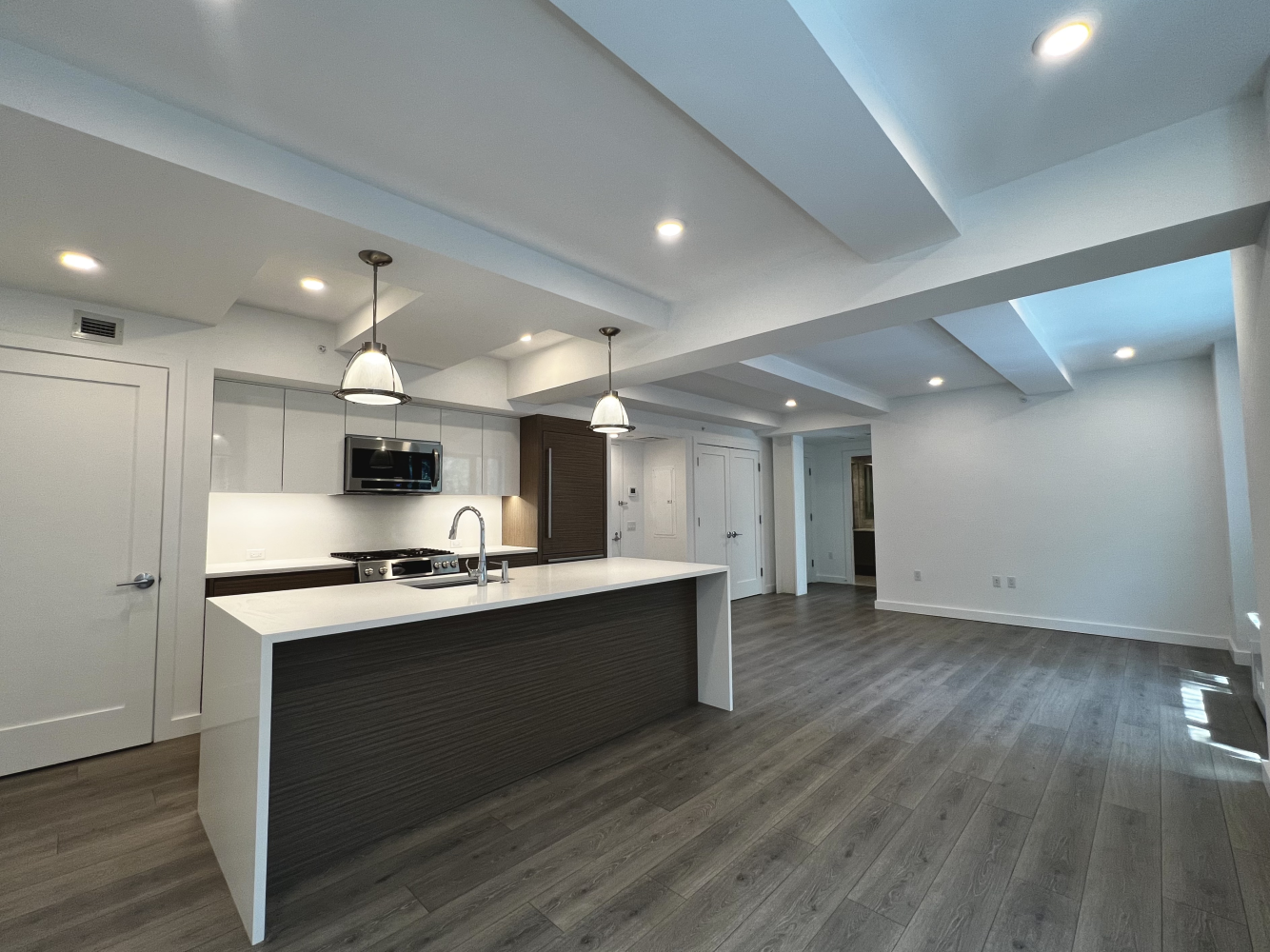 a kitchen with stainless steel appliances granite countertop a sink stove and wooden floor