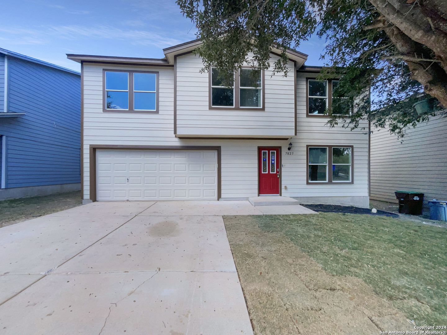 a front view of a house with a yard and garage